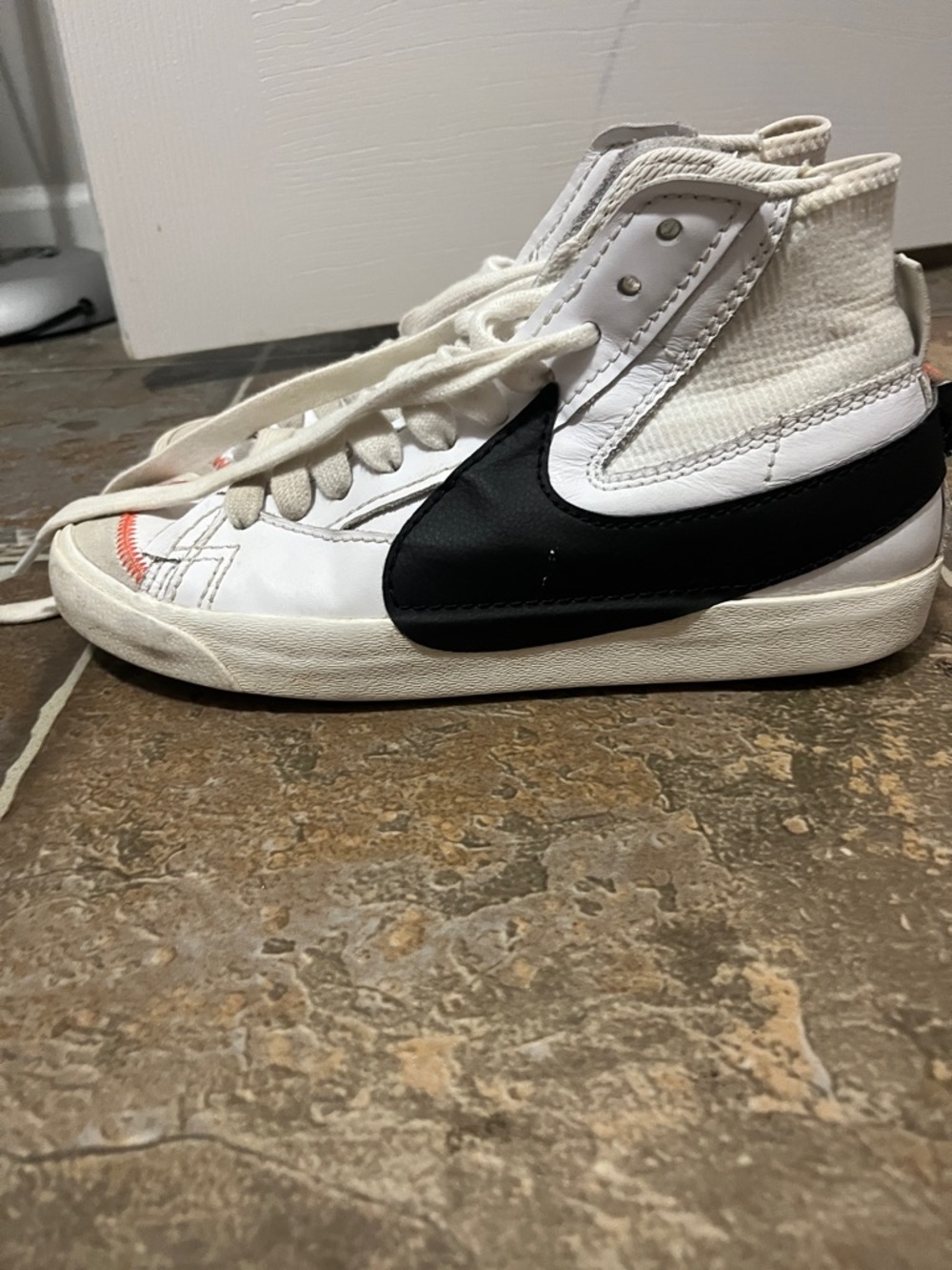 Nike White High-Top Sneaker with Black Swoosh